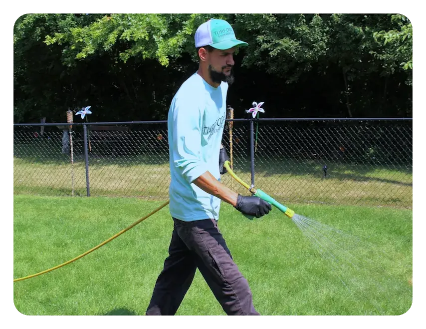 turf doctor tech spraying grass