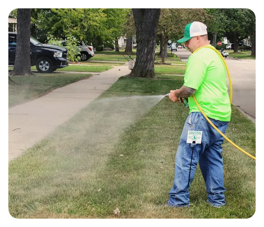 turf doctor tech spraying grass