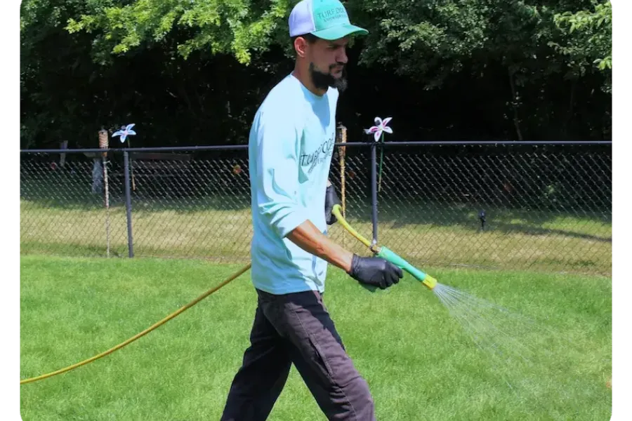 turf doctor tech spraying grass
