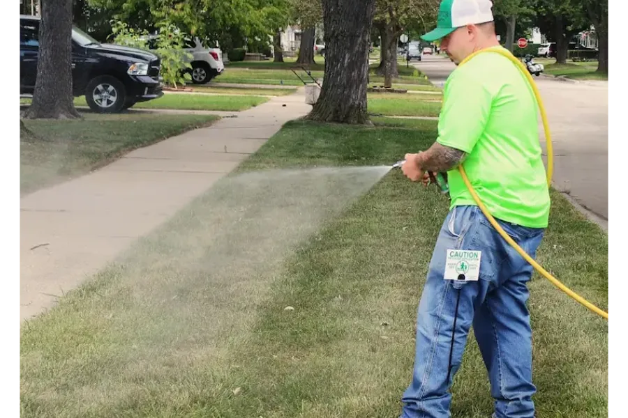 turf doctor tech spraying grass