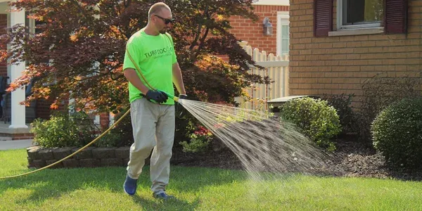 Technician spraying lawn
